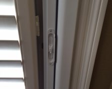 INSIDE MOUNT ROLL-AWAY ON DOORWAY WITH PLANTATION SHUTTERS