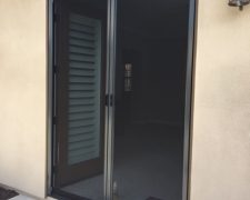 TALL BRONZE FRENCH ROLL-AWAY RETRACTABLE SCREEN DOORS IN USE