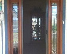 BRONZE ROLL-AWAY DISAPPEARING SCREEN DOOR IN USE