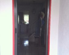 BRONZE ROLL-AWAY SCREEN DOOR IN USE