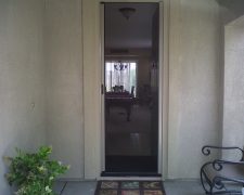 CHAMPAGNE BEIGE ROLL-AWAY INVISIBLE SCREEN DOOR IN USE