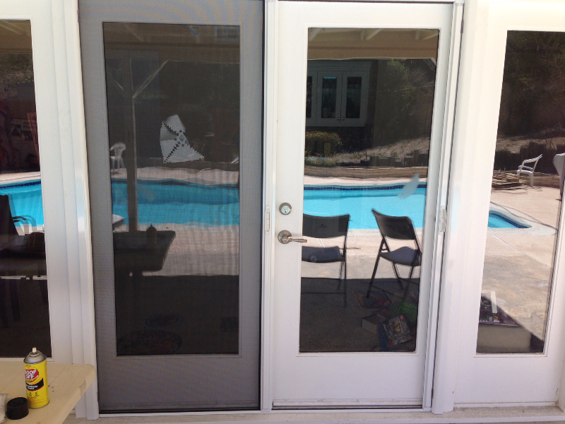 WHITE FRENCH ROLL-AWAY SCREEN DOORS WITH FIXED DOOR LOCKED IN PLACE