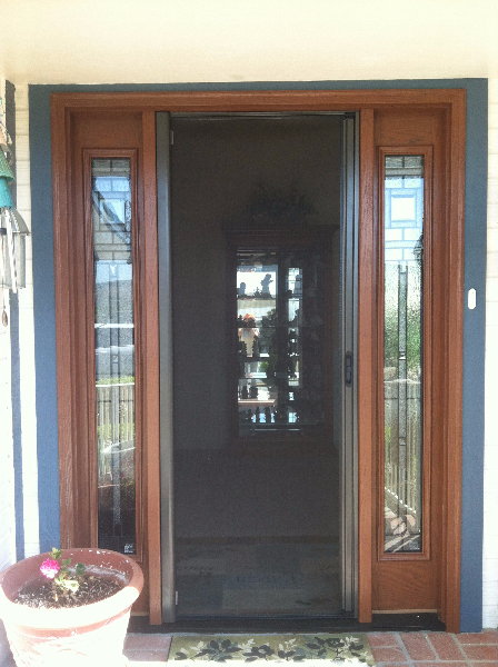BRONZE ROLL-AWAY DISAPPEARING SCREEN DOOR IN USE