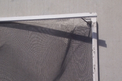 TORN AND CORRODED WINDOW SCREEN
